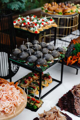 Mini burgers snacks on a wooden table, beautifully decorated catering banquet table on a corporate, christmas, birthday party event or wedding celebration