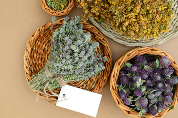 Phytotherapy, dried medicinal plants and herbs on the background of a wooden table, top view. Dried...