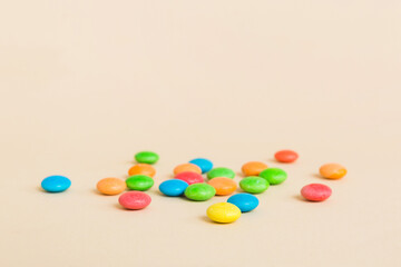 Pile of delicious colorful sweet candies on colored background top view. Confectionery decor