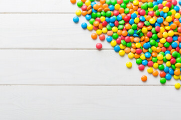 Mixed collection of colorful candy, on colored background. Flat lay, top view. frame of colorful chocolate coated candy