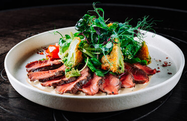 Roast beef salad with vegetables on plate