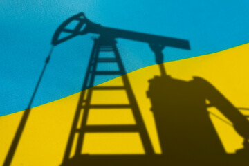 purchase of oil in Ukraine. Oil rigs on the background of the ukrainian flag. Mining and oil...