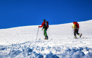 Fototapeta na wymiar Cross-country skiing on snowy hillside. Winter season sport activities