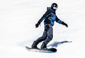 Fototapeta na wymiar Snowboarding. Snowboarder on the slope. Winter sport activities