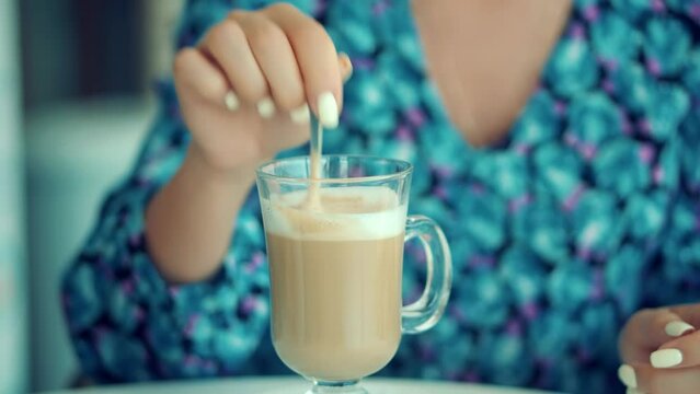 woman drinking latte coffee .  drinking cappuccino In cafeteria