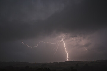 Obraz na płótnie Canvas Storm clouds and lightning over the countryside