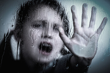 Children violence. Portrait of young girl with her hand extended showing STOP gesture. Selective focus.