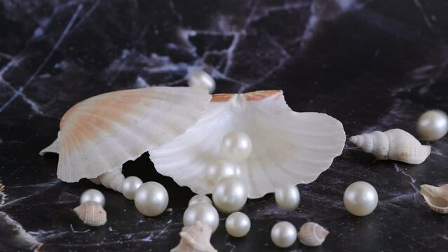 white pearls fall into the shell