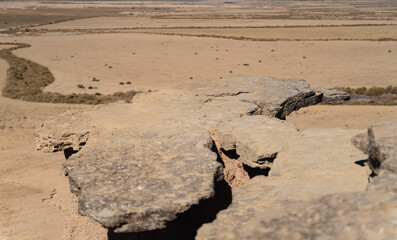 Plain rock viewpoint to the desert, focus on rock