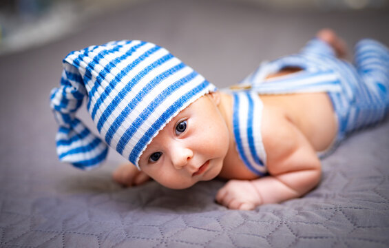 Newborn baby. First photo shoot. Baby boy in a gnome costume.