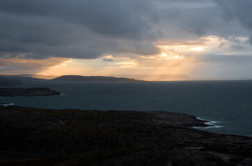 Dramatic cloudy sunset over the turbulent northern sea