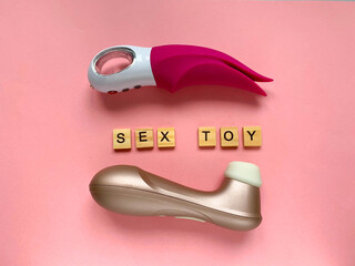 Sex toys. Two vibrators on a pink background. Lettering SEX TOY. Useful for sex shop, adult