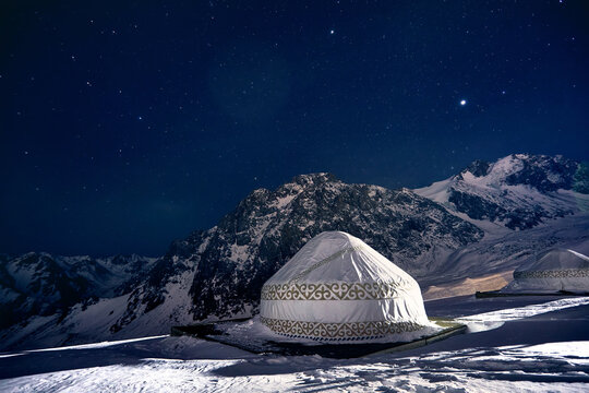 White Yurt nomadic house at night in the Mountains