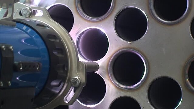 Welding shell and tube in tube heat exchanger. Welding head equipment. Automatic welding machine. Skilled welder. Back View. Static shot.