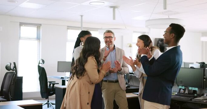 Winner, cheering and high five with a business team in celebration of a goal or target together in their office. Motivation, success and team building with a man and woman employee group celebrating