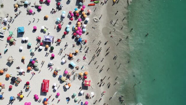 Aerial view of Clifton 4th beach with colourful umbrellas in summer, Cape Town, South Africa.