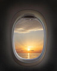 Airplane window with beautiful sky. Airplane window. Sea view, sunset and clouds. Travel and...