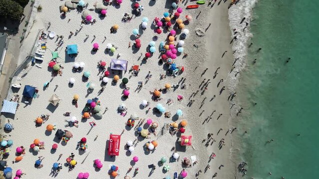 Aerial view of Clifton 4th beach with colourful umbrellas in summer, Cape Town, South Africa.