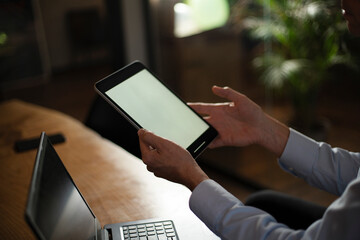 Close up of man using digital tablet