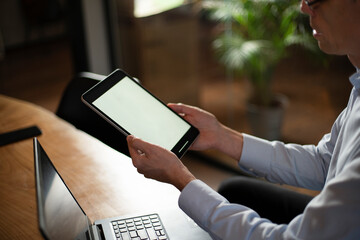 Close up of man using digital tablet