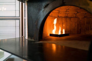 Inside the oven for Baking Neapolitan pizza in a gas-fired classic Italian pizza oven with high temperature. Crusts will quickly rise and toppings become lightly charred and crispy. Traditional baked