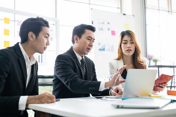 Fototapeta premium Professional Asian business adviser meeting to analyze and discuss the strategy of financial support of a tech company. Partnership start-up consultant, Indoor business client consultation concept.