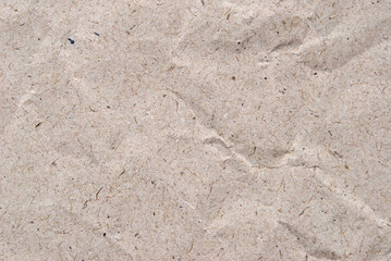 A sheet of beige crumled recycled paper texture as background