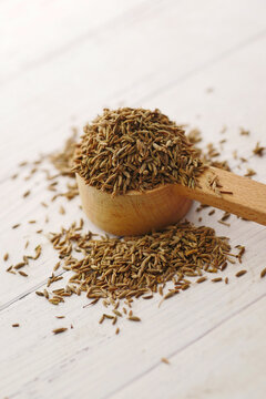 cumin seeds on spoon on table , close up 