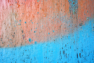 old wooden plank wall with old faded peeling green, yellow paint