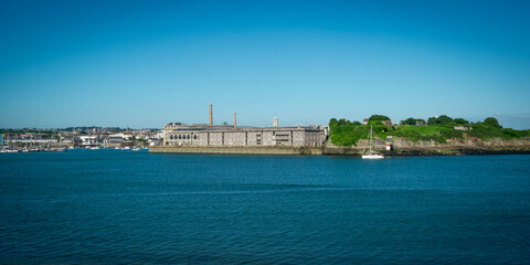 View across the busy water towards Plymouth from Mount Edgcumbe Country Park, Cornwall, UK