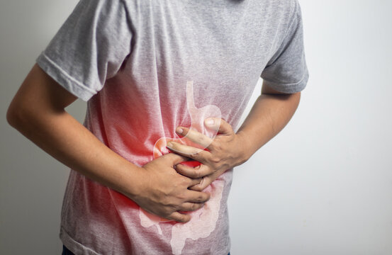 man having abdominal pain on white background