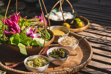 Thai food and culture concept, vegetables and curry, savory dishes, in woven wooden tray. - obrazy, fototapety, plakaty