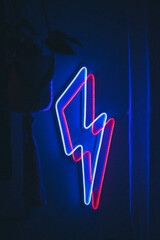 Blue lightning neon sign on a wall