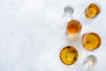 Alcoholic drinks in glasses with ice. Strong alcohol background