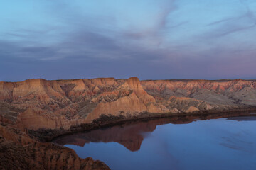 Red clay erosion gully and river. Panoramic eroded landscape. Spain
