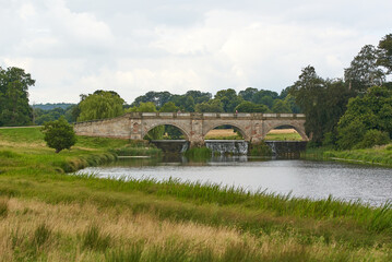 Fototapeta na wymiar Old stone bridge in a country estate