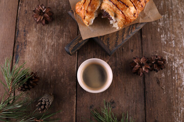 Fototapeta premium Croissant with chocolate on a wooden board on a wooden board