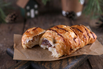 Croissant with chocolate on a wooden board on a wooden board