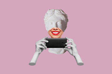 Young smiling woman headed by antique statue with red lips holds mobile phone isolated on a pink background. 3d trendy collage in magazine style. Contemporary art. Modern design - Powered by Adobe