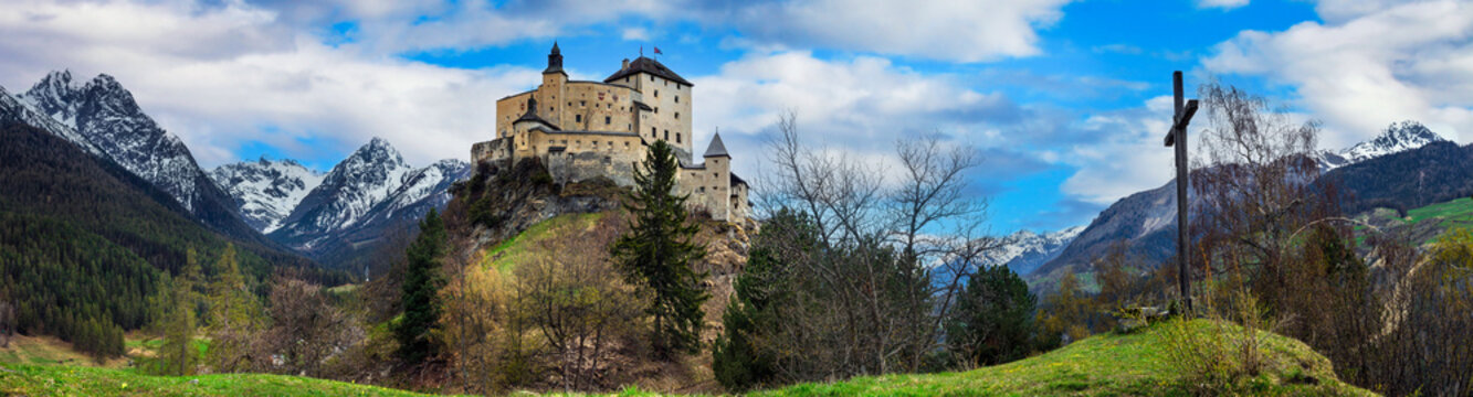  Switzerland travel and landmarks. Impressive  mountain scenery with amazing medieval castle Tarasp surrounded by  Swiss Alps, Canton Grisons or Graubuendon
