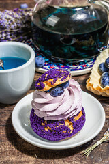 The concept of romantic tea. French Shu cake, Lavender tea, blueberries, festive decor