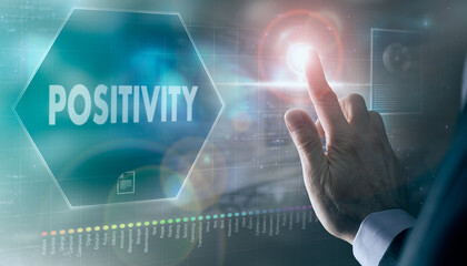 A businessman controlling a futuristic display with a Positivity business concept on it.