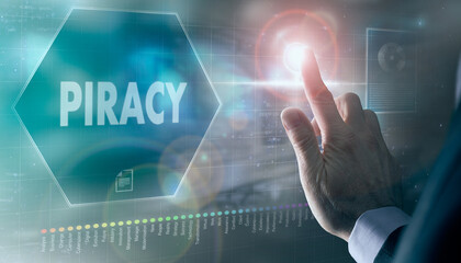 A businessman controlling a futuristic display with a Piracy business concept on it.