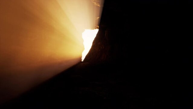 The stone opens a tomb in the rock, letting bright light into the cave.