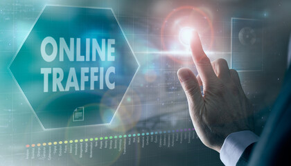 A businessman controlling a futuristic display with a Online Traffic business concept on it.