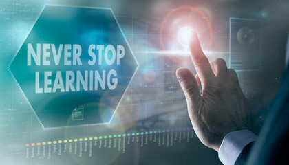 A businessman controlling a futuristic display with a Never Stop Learning business concept on it.