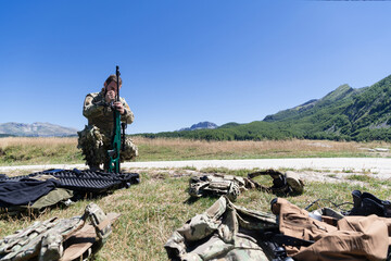 Special operations soldiers team preparing tactical and communication gear for action battle. Long distance sniper team in checking gear for action
