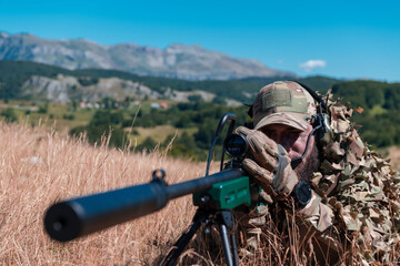 Army soldier holding sniper rifle with scope and aiming in forest. War, army, technology and people...