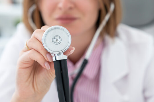 Close-up photo of female doctor holding stethoscope in the office of modern clinic in health care and medical check up concept