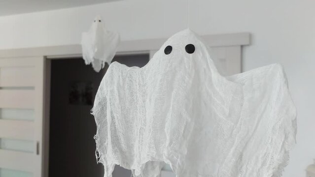 Two white rag ghosts flying in the room